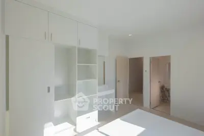 Bright minimalist bedroom with built-in storage and ensuite bathroom