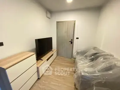 Modern living room with sleek furniture and TV setup, perfect for cozy relaxation.