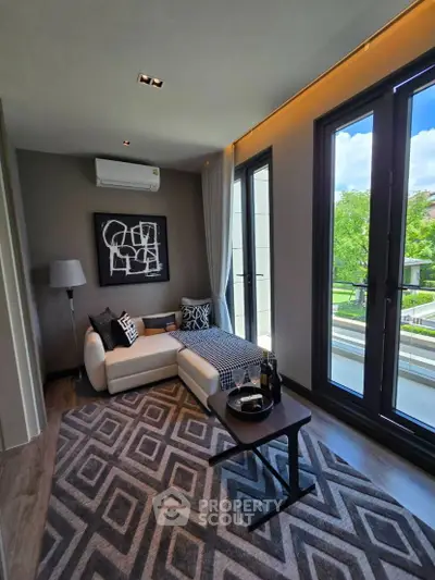 Stylish living room with modern decor and large windows offering a scenic view.