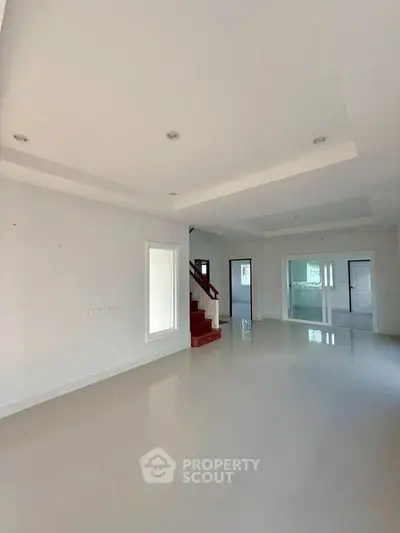 Spacious modern living room with sleek staircase and open layout
