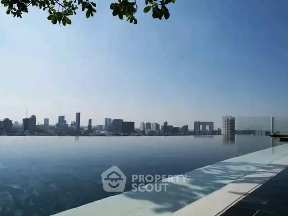 Stunning infinity pool with breathtaking city skyline view, perfect for luxury living.