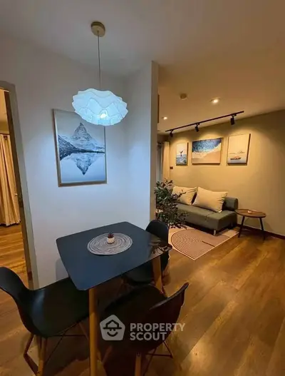 Cozy living room with modern decor and stylish dining area, perfect for urban living.