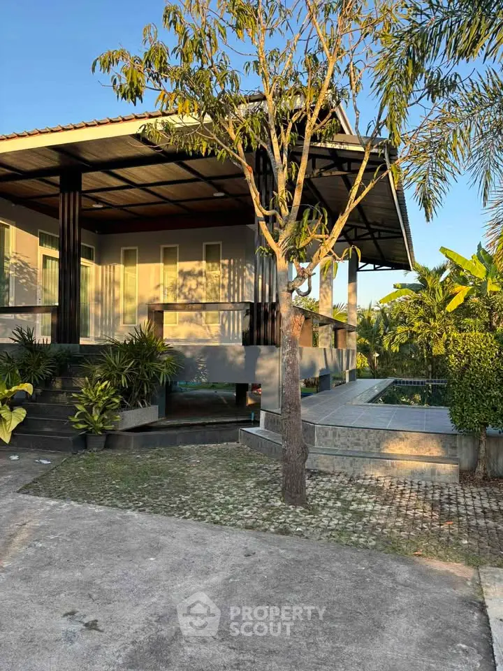 Modern house with lush garden and pool, perfect for serene living.