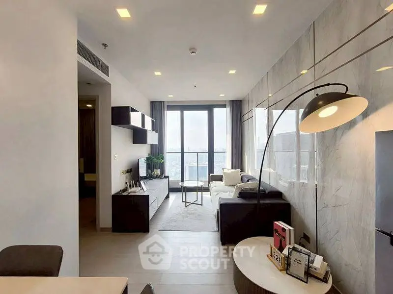 Modern living room with floor-to-ceiling windows and stylish decor