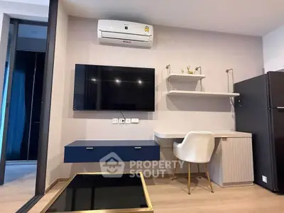 Modern living room with sleek furniture, wall-mounted TV, and air conditioning unit.