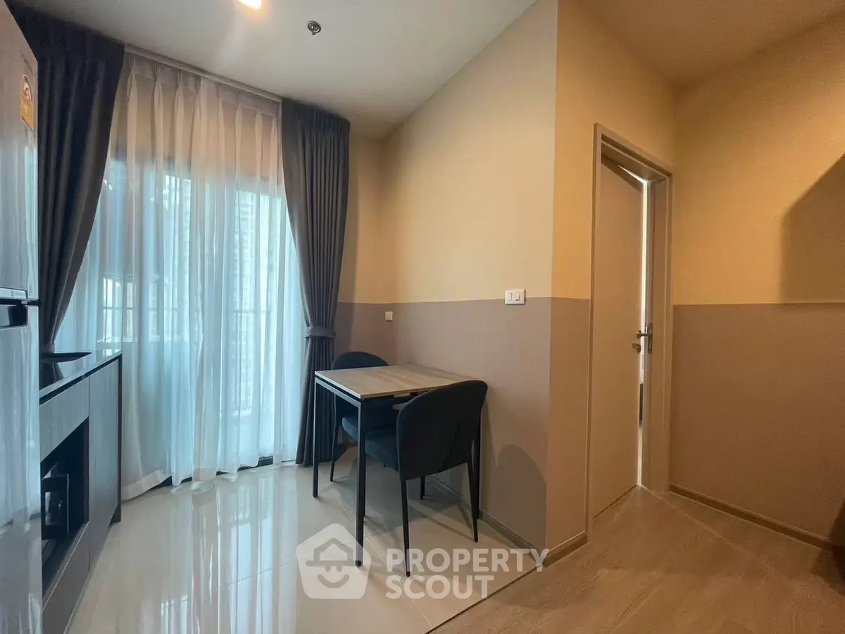Modern apartment interior with dining area and large window