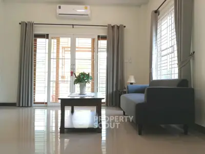 Spacious living room with modern sofa and large windows for natural light