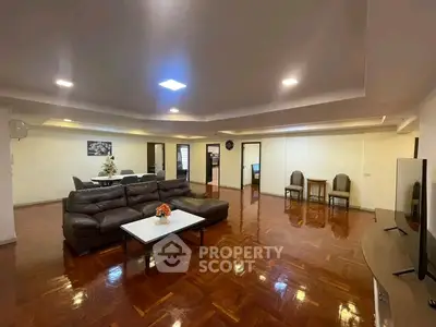 Spacious living room with elegant wooden flooring and modern furniture