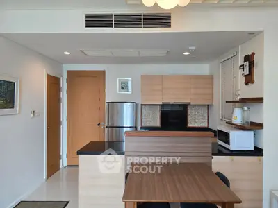 Modern kitchen with sleek wooden cabinetry and stainless steel appliances