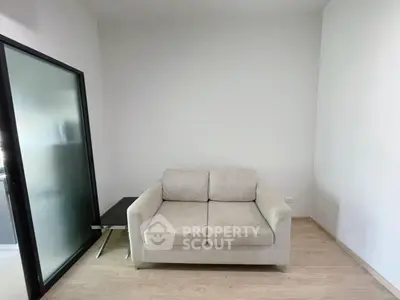 Cozy small living area with modern armchair and side table, perfect for compact spaces.