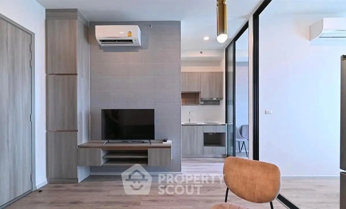 Modern living room with sleek design and open kitchen layout