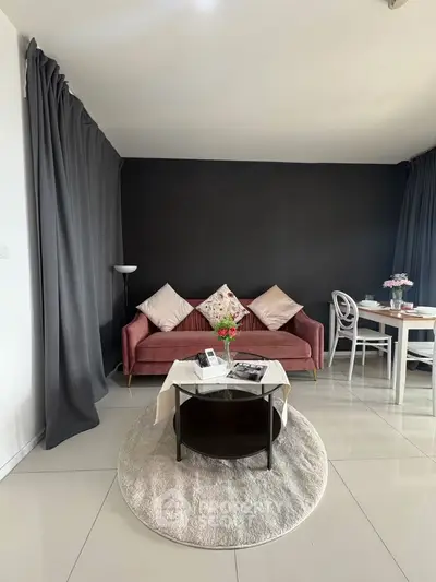 Stylish living room with modern decor, featuring a cozy sofa, elegant curtains, and a chic dining area.