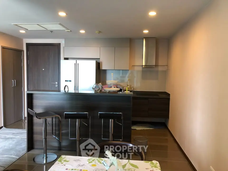 Modern kitchen with sleek cabinetry and breakfast bar in a stylish apartment