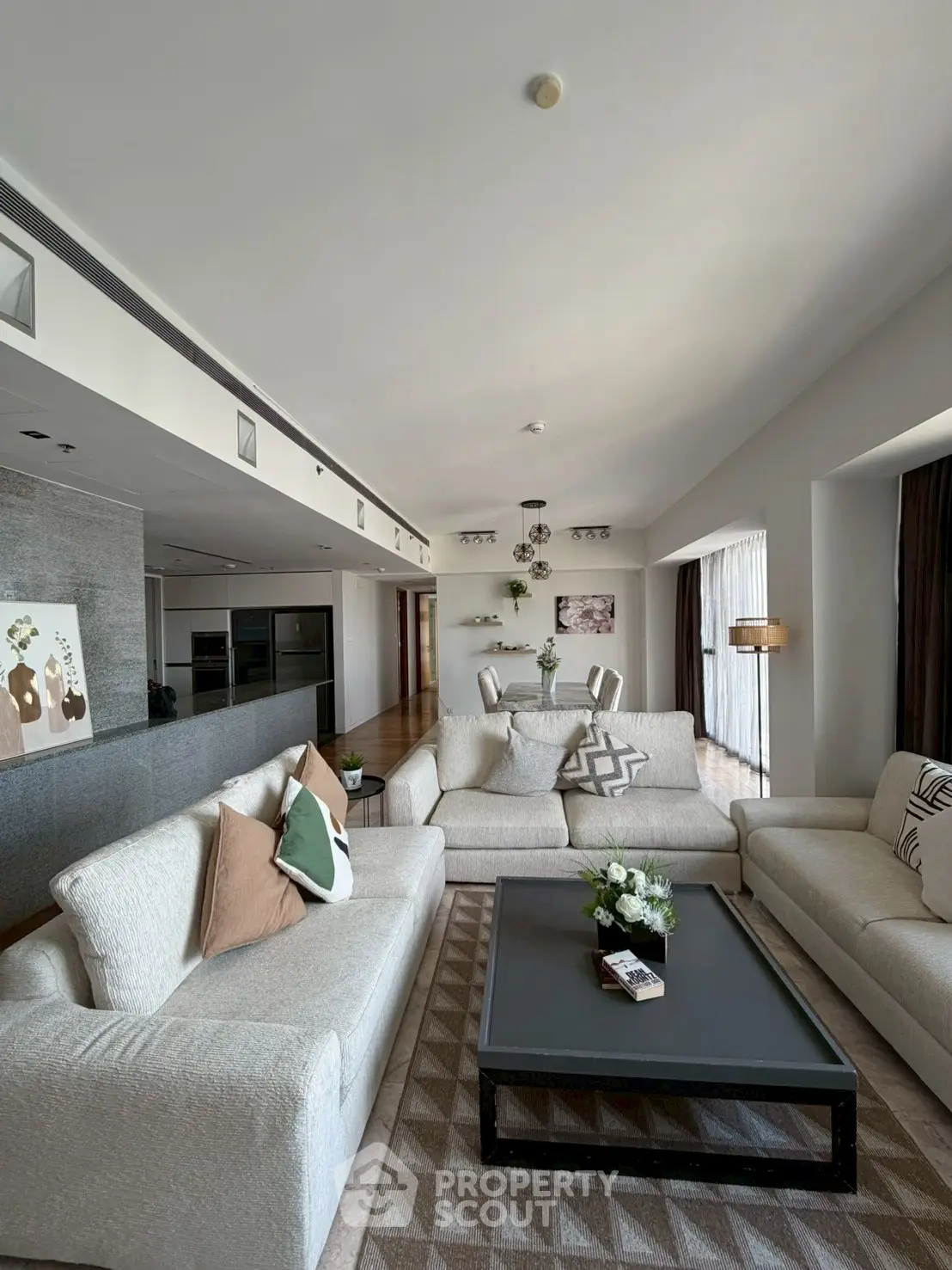 Spacious modern living room with elegant decor and dining area