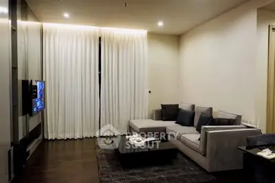 Modern living room with sleek furniture and ambient lighting, perfect for relaxation and entertainment.