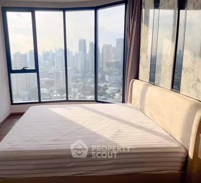 Spacious bedroom with panoramic city view and elegant decor