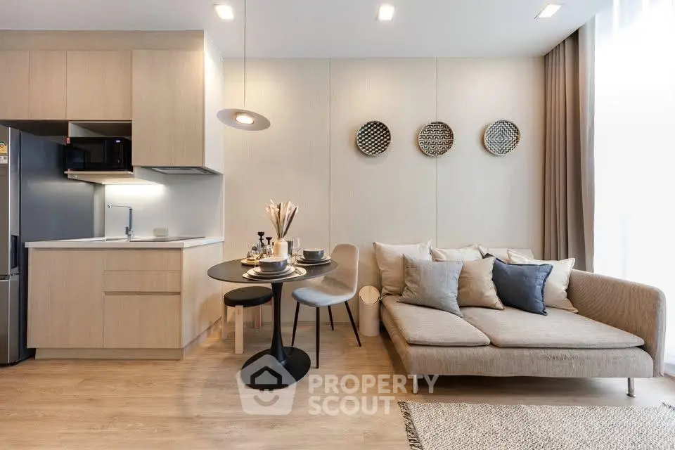 Modern open-layout living room with cozy sofa and stylish kitchen area