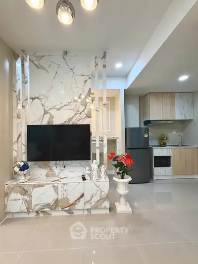 Modern living room with marble TV wall and open kitchen layout