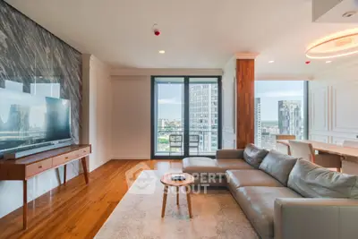Luxurious living room with modern decor and city view balcony in high-rise apartment.