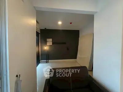Modern interior with sleek black and white design, featuring a cozy seating area and minimalist decor.