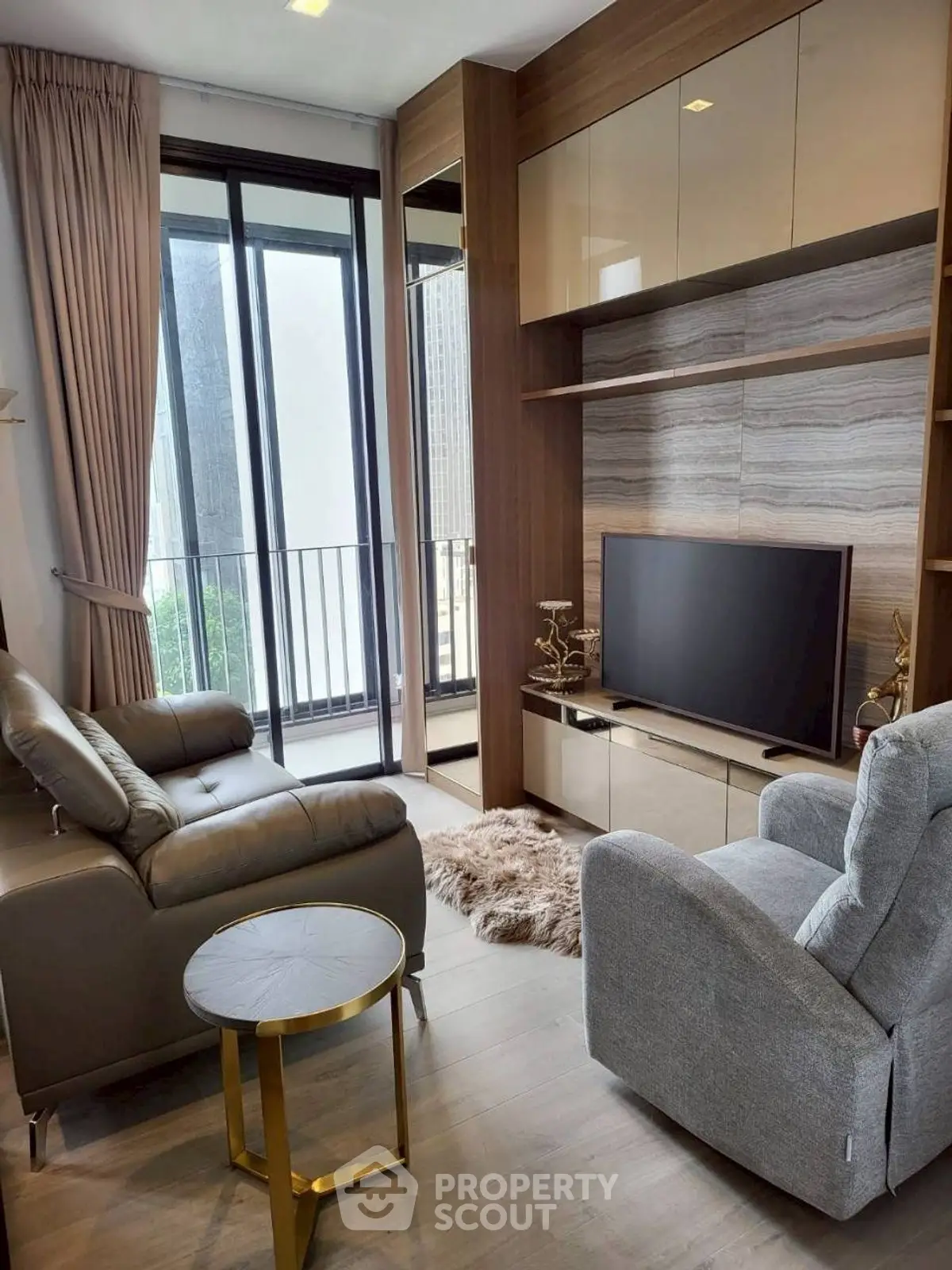 Modern living room with cozy seating and stylish decor in a high-rise apartment.