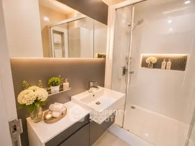 Modern bathroom with sleek design, glass shower, and elegant fixtures.
