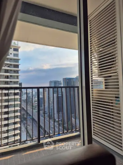 Stunning city view from a modern balcony with sleek railing and urban skyline.