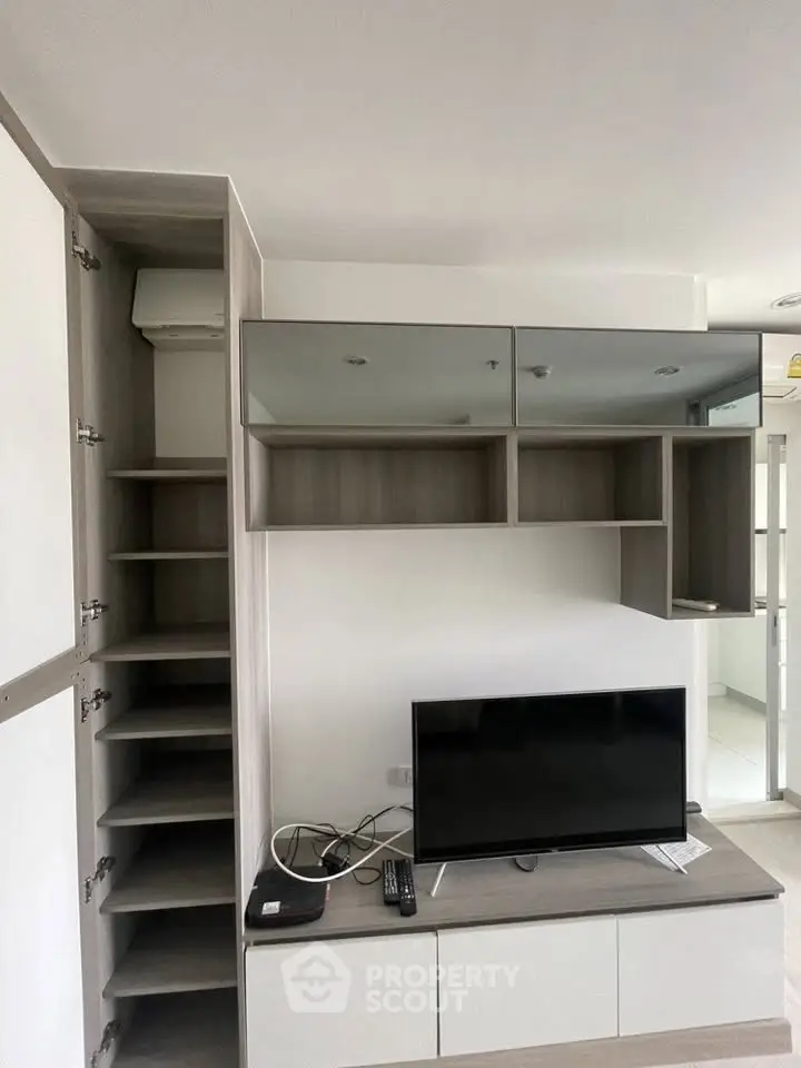 Modern living room with sleek TV unit and ample storage space