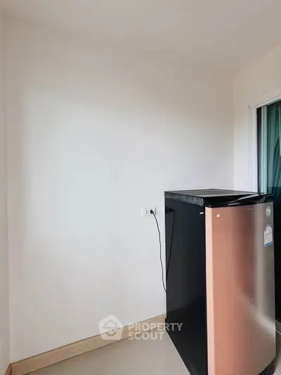 Compact kitchen corner with modern fridge in minimalist apartment