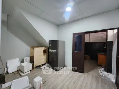 Spacious storage room with modern fridge and ample shelving potential
