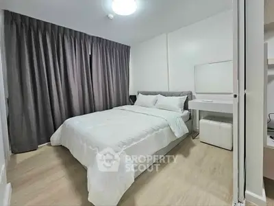 Modern bedroom with cozy bedding and elegant decor in a stylish apartment.