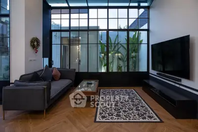 Modern living room with large glass windows, stylish furniture, and elegant decor.