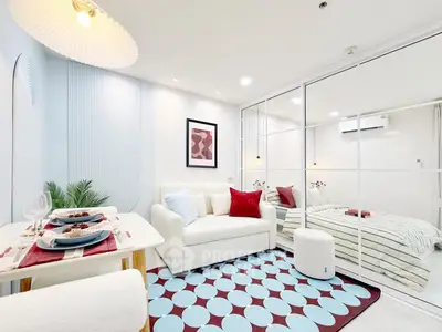 Modern living room with stylish decor and cozy dining area in a bright apartment.