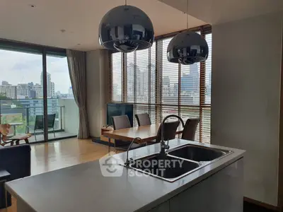 Modern open-plan living room with city view and stylish kitchen island