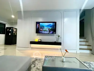 Modern living room with wall-mounted TV and stylish decor