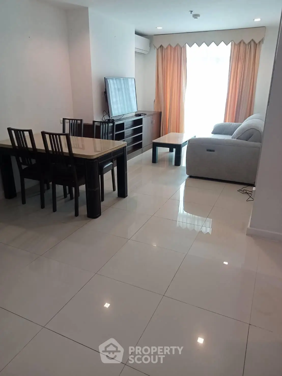 Spacious living room with modern furniture and large windows for natural light.