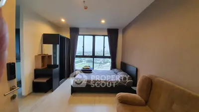 Modern bedroom with city view, featuring cozy bed and stylish furniture in high-rise apartment.