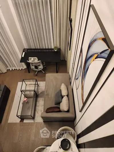 Modern living room with high ceilings, stylish decor, and a cozy seating area, perfect for urban living.