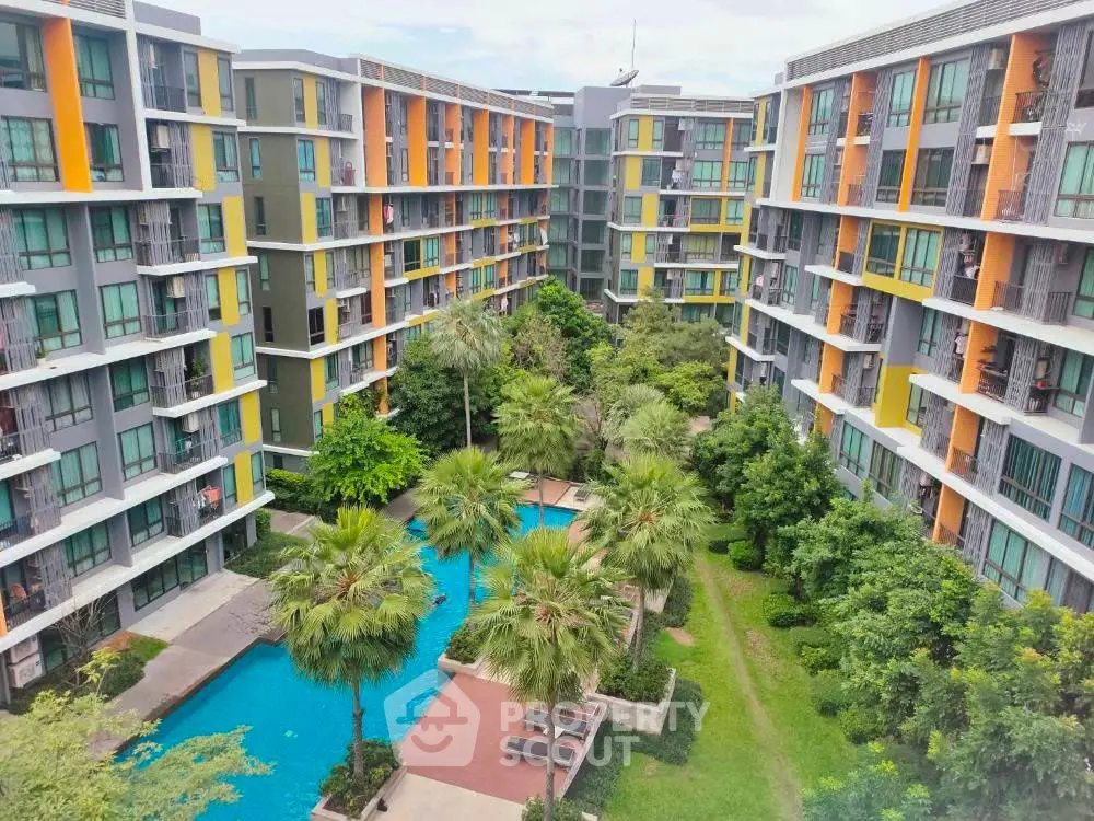 Modern apartment complex with lush garden and pool view
