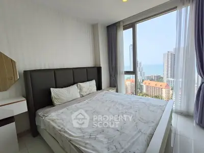 Modern bedroom with stunning city view and large windows in high-rise apartment