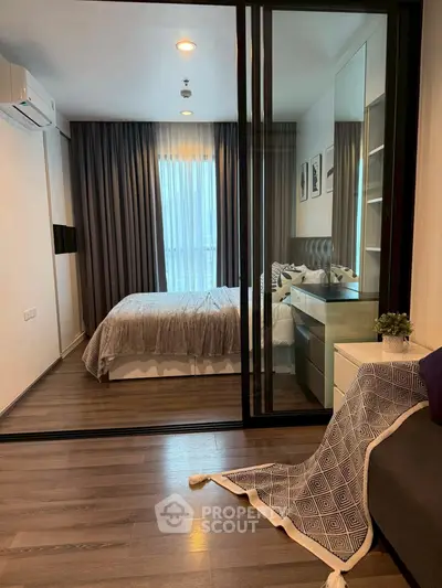 Modern bedroom with elegant decor and large window in a stylish apartment.