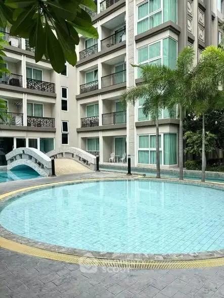 Luxurious condominium with pool and lush greenery, perfect for modern living.