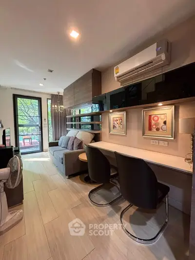 Modern living room with stylish decor and natural light, featuring a cozy sofa and elegant dining area.