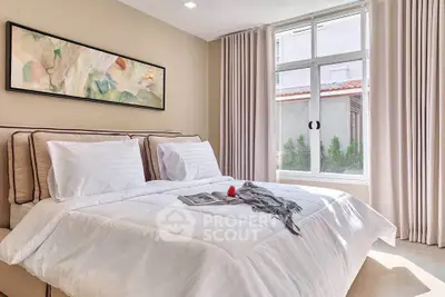 Elegant bedroom with large window and stylish decor, perfect for relaxation and comfort.