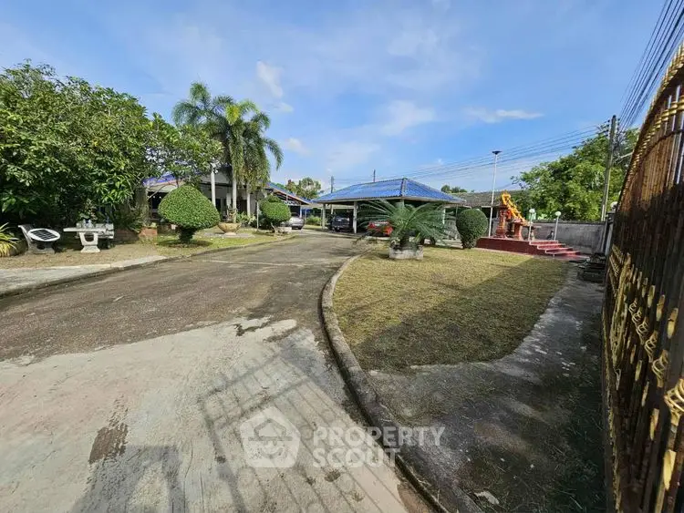 Spacious property with lush garden and driveway in serene neighborhood.