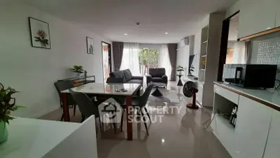 Spacious modern living room with dining area and balcony access