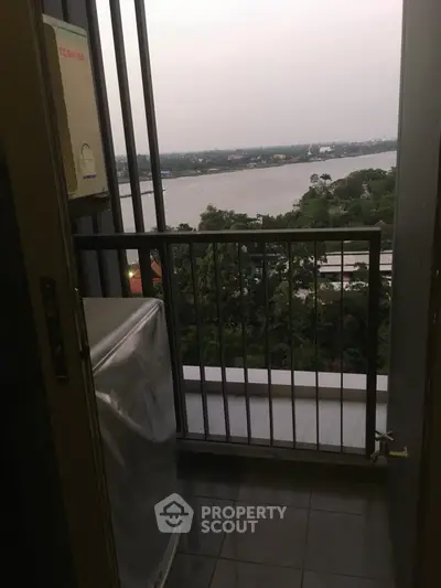 Stunning balcony view overlooking a serene river and lush greenery, perfect for relaxation.