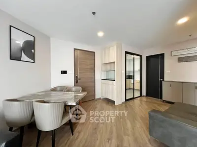 Modern living room with dining area and open kitchen in stylish apartment