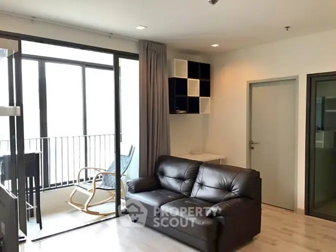 Modern living room with balcony access and stylish furniture