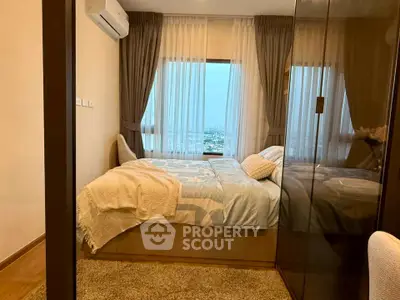 Cozy bedroom with city view, modern decor, and ample natural light.